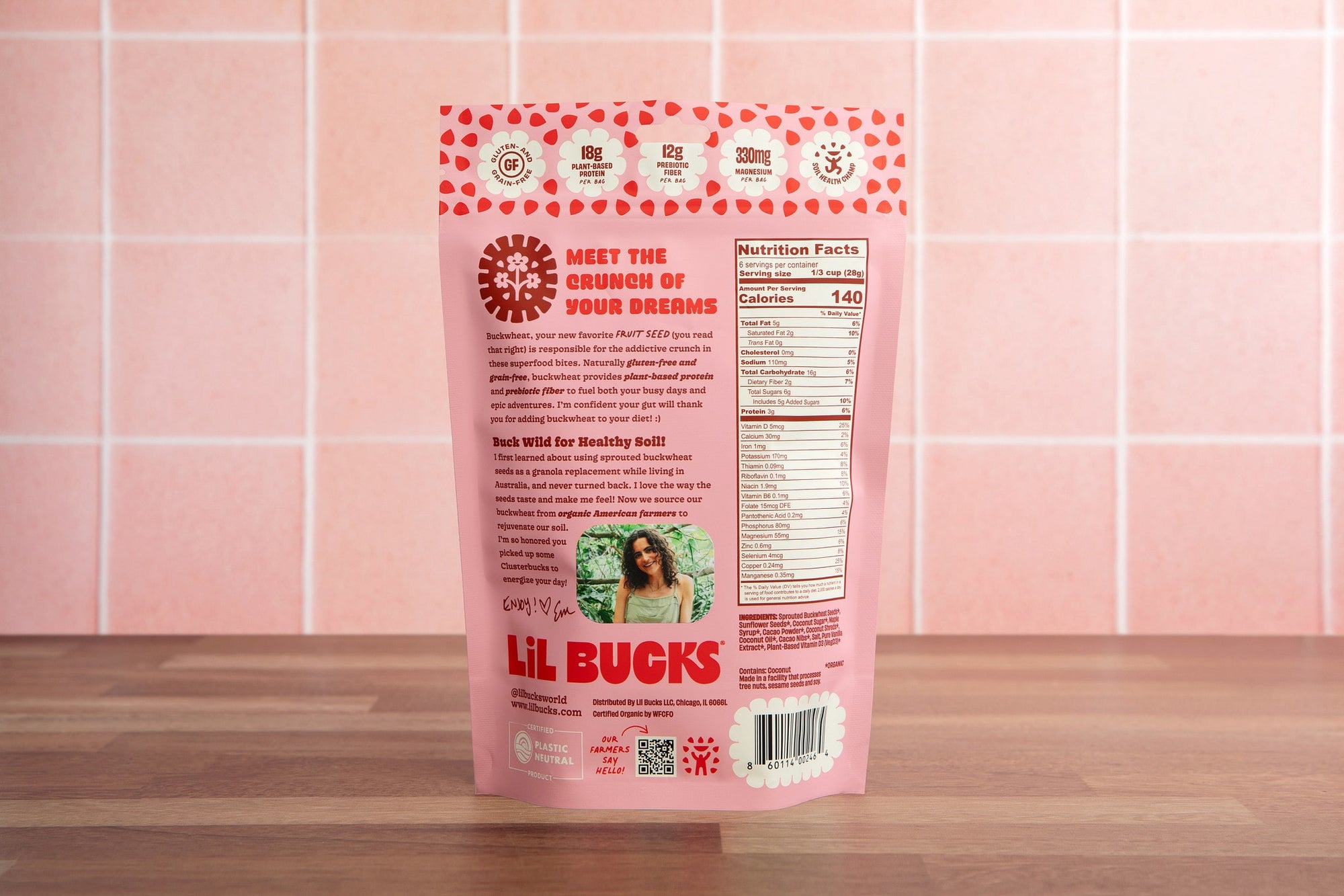 Back of Pink package of Lil Bucks on a wooden surface with pink tiled wall background