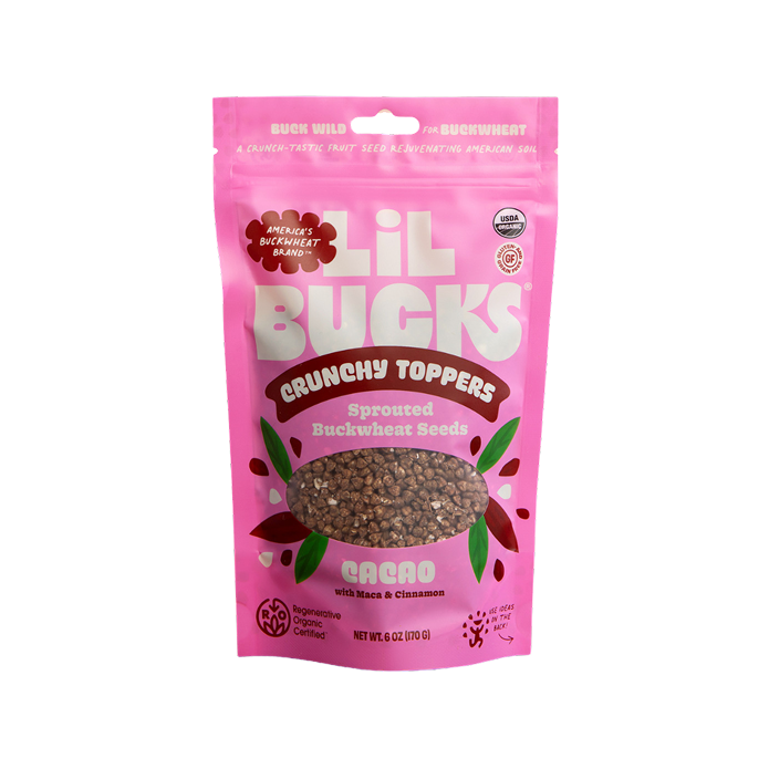 Pink package of Lil Bucks Crunchy Toppers with buckwheat seeds on a white background