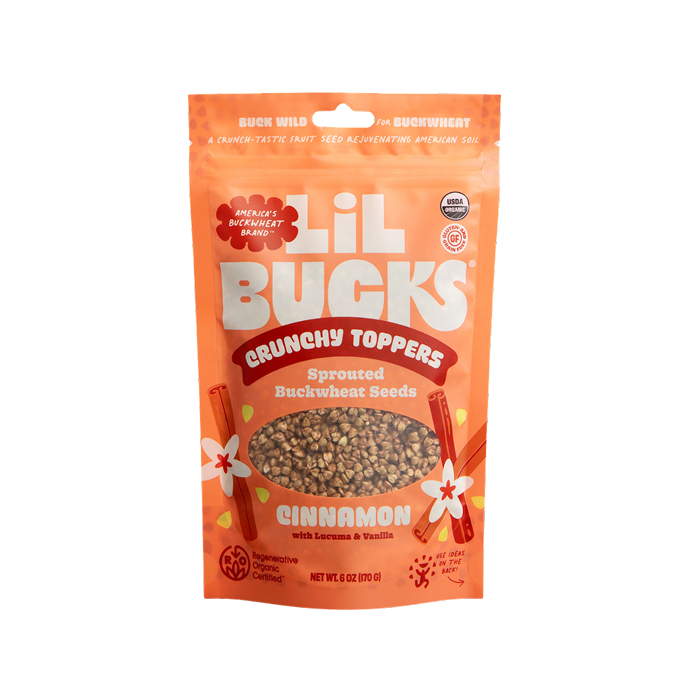Orange packaging of Lil Bucks Crunchy Toppers Sprouted Buckwheat Seeds Cinnamon flavor 