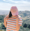 girl wearing lil bucks pink baseball cap